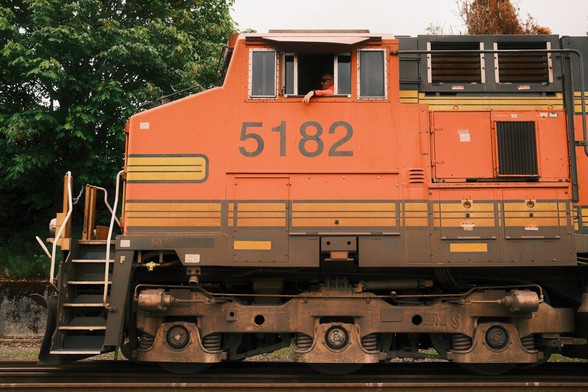 An orange BNSF diesel electric locomotive.