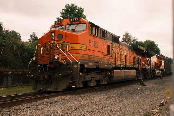 An orange BNSF diesel electric locomotive.